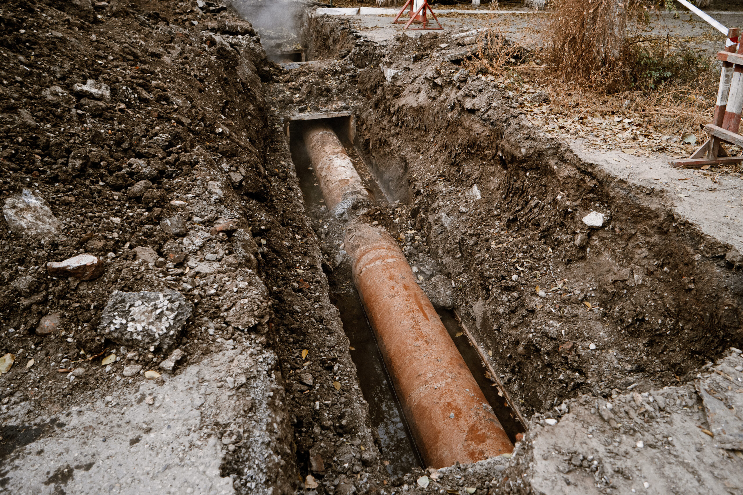 rusty water pipe in the trench ground view